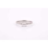 A princess cut diamond ring, claw set in platinum with eight pave set round billiant cut diamonds to