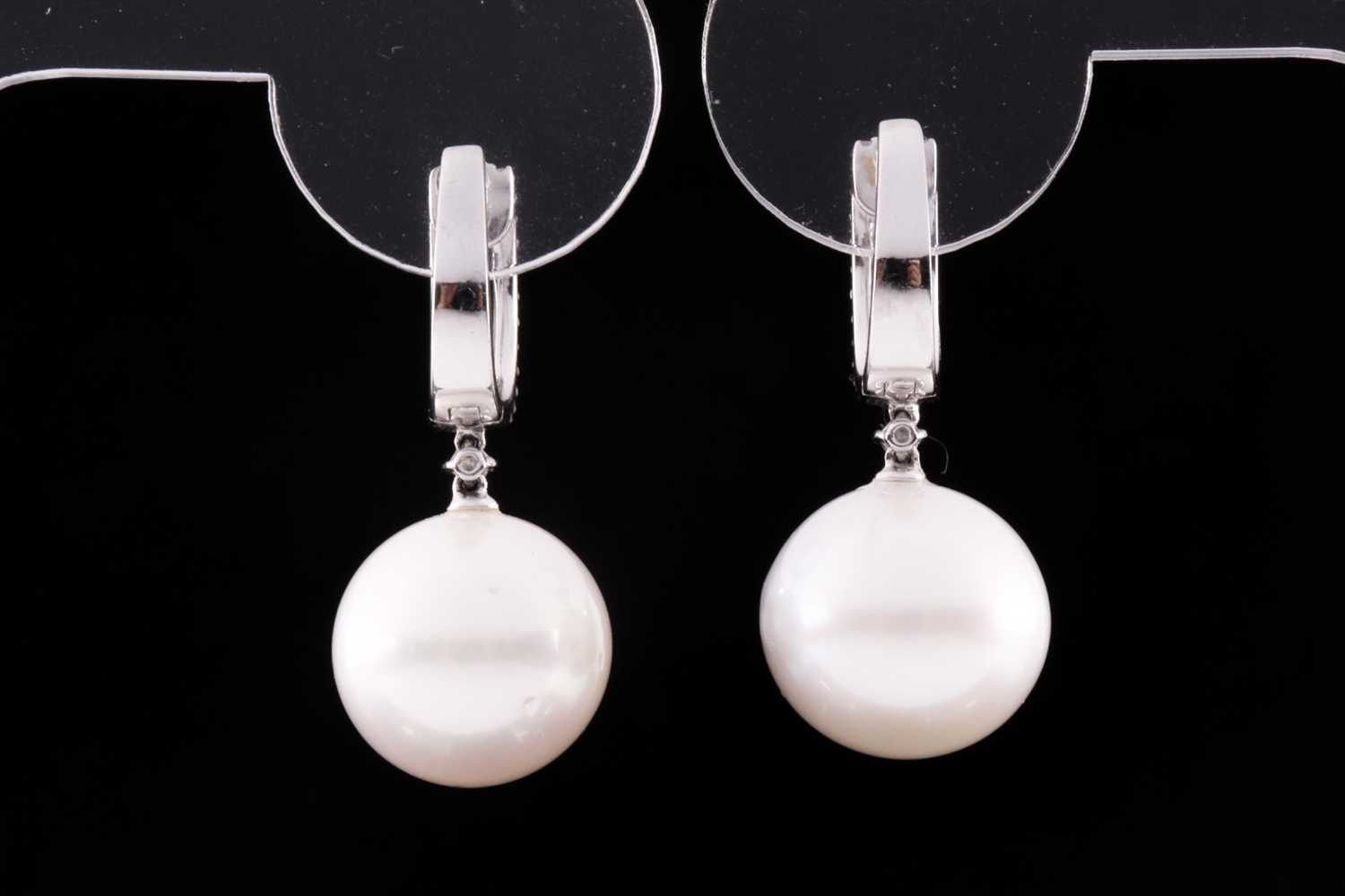 A pair of 18ct white gold, diamond, and pearl drop earrings, each hooped mount pave-set with round - Bild 2 aus 3
