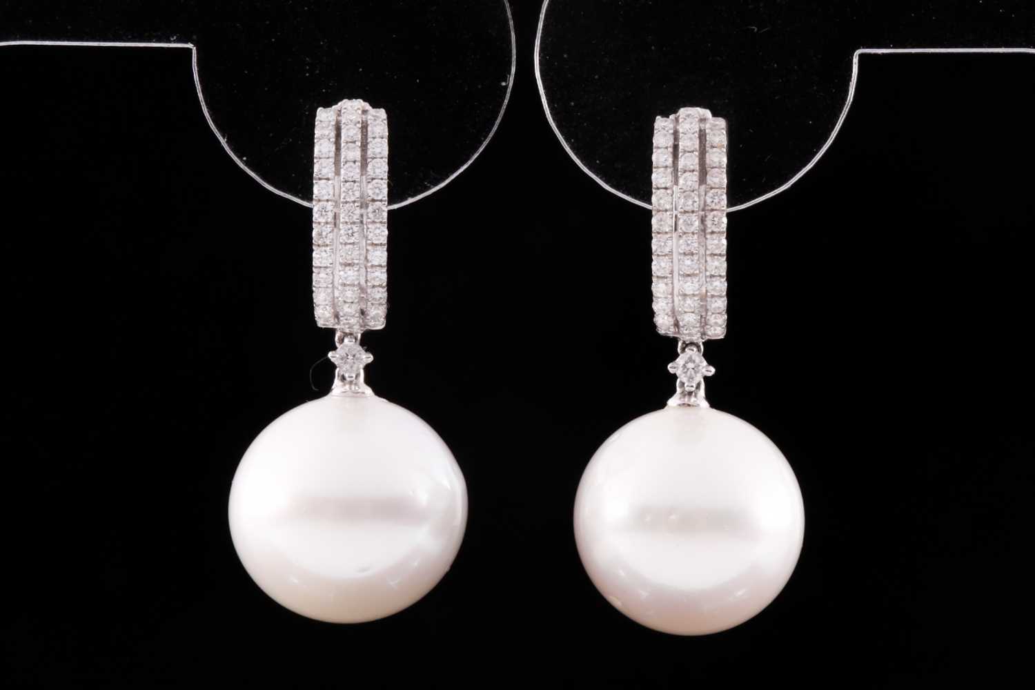 A pair of 18ct white gold, diamond, and pearl drop earrings, each hooped mount pave-set with round