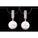 A pair of 18ct white gold, diamond, and pearl drop earrings, each hooped mount pave-set with round