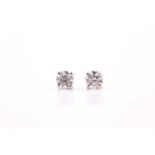A pair of solitaire diamond earrings, set with round brilliant-cut diamonds of approximately 1.02