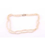 A double strand of cultured pearls with 9ct gold and cultured pearl cluster clasp, comprising of
