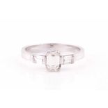 An 18ct white gold and diamond ring, set with an emerald-cut diamond of approximately 0.40 carats,