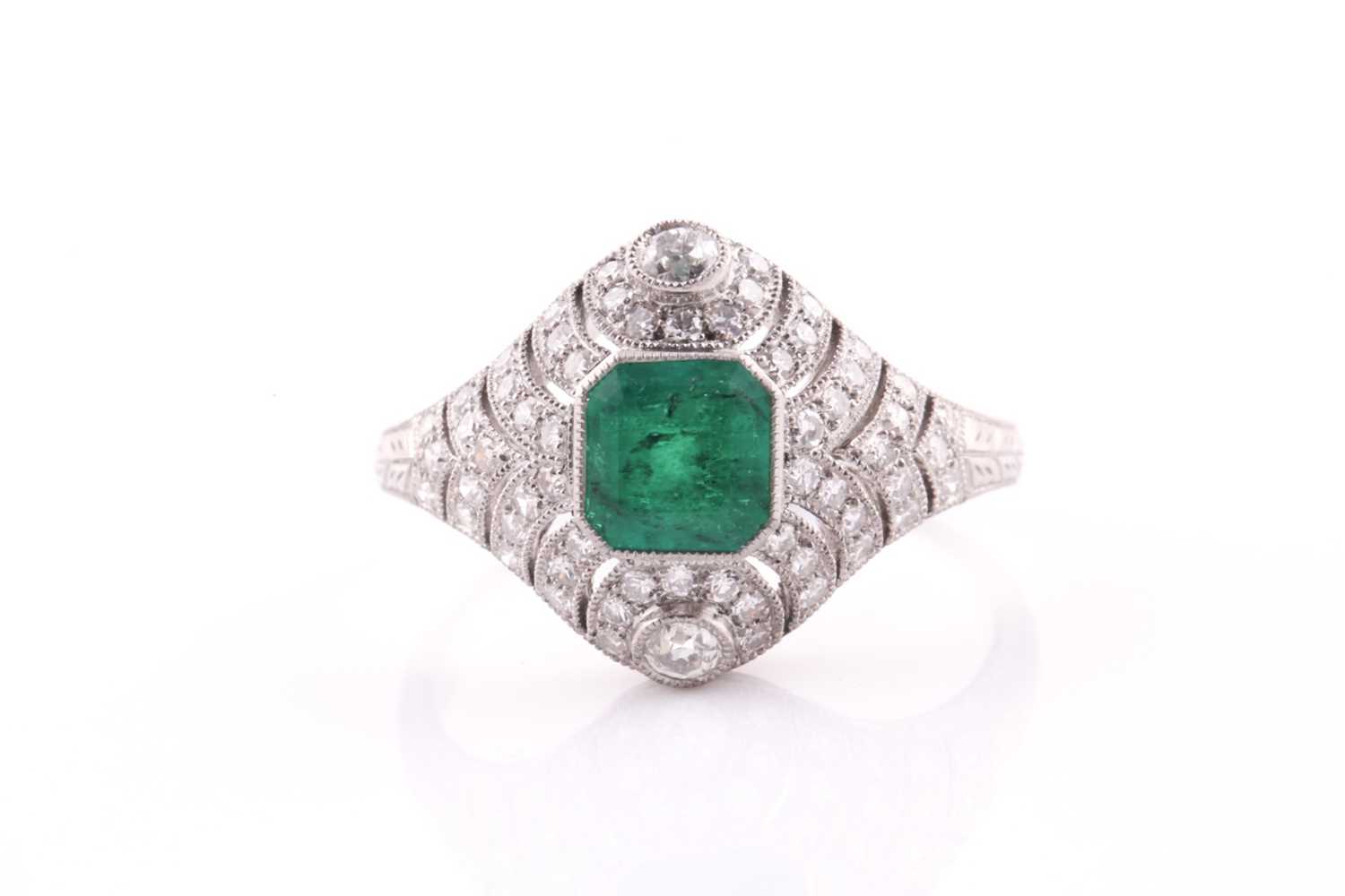 A platinum, emerald, and diamond ring, centred with a mixed square-cut emerald of approximately 0.79