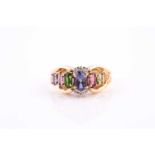 A yellow metal and multi-gem set ring, set with mixed oval-cut citrine, tourmaline, green