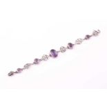 An Arts & Crafts silver and amethyst bracelet by Arthur and Georgie Gaskin, circa 1910, set with