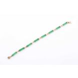 A 14ct yellow gold and jade bracelet, the smooth baton links with yellow metal terminal mounts,