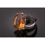 A diamond and citrine cocktail ring, set with a mixed-cut citrine, the claws and split shoulders