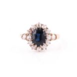 An Edwardian 18ct yellow gold, diamond, and sapphire cluster ring, set with a mixed oval-cut