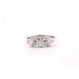 A platinum and diamond ring, set with three round brilliant-cut diamonds of approximately 1.20