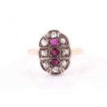 An 18ct yellow gold, diamond, and ruby ring, the oval mount inset with mixed rose-cut diamonds and