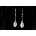 A pair of diamond and pearl drop earrings, white metal hooks, suspended with three bezel-set rose-