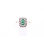 An 18ct yellow gold, diamond, and emerald ring, set with an emerald-cut emerald within a border of