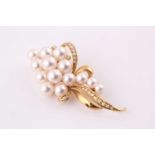 Mikimoto. A gold, diamond and pearl brooch; the stylised spray formed from fourteen vari-sized
