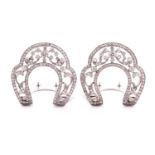 A pair of diamond lapel clips, the horse-shoe shaped mounts with openwork scrolled design millegrain