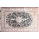 A 20th-century dark blue ground Kashan carpet with central medallion, lanterns and corners. Within
