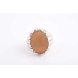 An Indo Persian white metal and hardstone ring, set with a pale orange onyx hardstone with