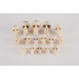 A collection of sixteen native American carved moose antler miniature skulls. The largest 26mm high,