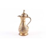 An Ottoman-style baluster form gilt brass coffee pot, with star and crescent finial to the hinged