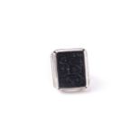 An Eastern white metal and black onyx gentleman's ring, the rectangular stone with intaglio cut