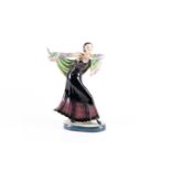 A mid-20th century ceramic figure of a dancer, Art Deco style, painted in polychrome enamels on an