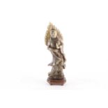 A carved soapstone figure of Guanyin, on an oval hardwood base, 25.5 cm high.Condition report: The