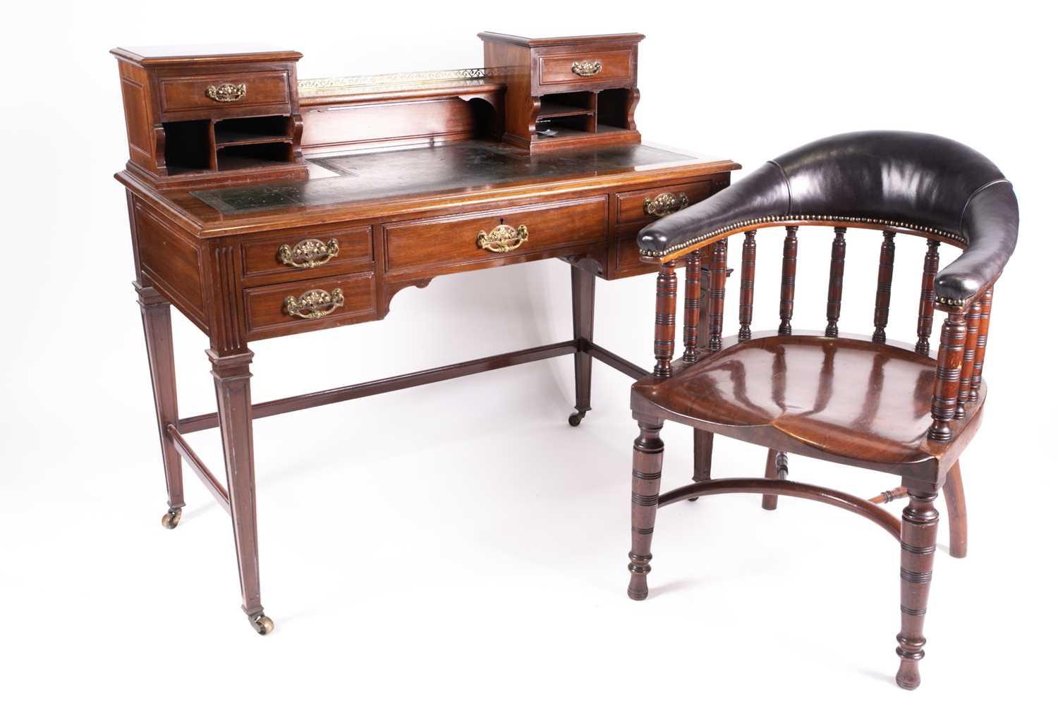 An Edwardian mahogany Bonheur du Jour with small drawers and pigeon holes above a leathered top, the