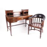 An Edwardian mahogany Bonheur du Jour with small drawers and pigeon holes above a leathered top, the
