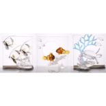 Three boxed Swarovski crystal commemorative items, from the 'Wonders of the Sea' series; '