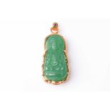An Eastern 18ct yellow gold and carved jadeite seated Buddha pendant. Marked 18K to the loop