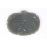 An Indo Persian bean shape jade pendant, engraved with a single calligraphic character, 4.9cm.