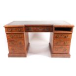 An Edwards and Roberts tulipwood crossbanded quarter cut oak kneehole writing desk, with leather
