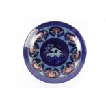 A contemporary Arts & Crafts style blue lustre charger, in the manner of John Pearson, the well with