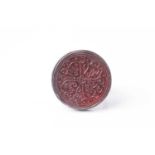 A probably Persian white metal gentleman's ring set with a circular bloodstone(?) panel engraved