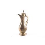 A Persian (Bokhara) brass coffee pot, Qajar Dynasty, With hinged domed cover, short angles spout,