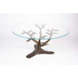 In the manner of Willy Daro (Belgian) a bronze and plate glass circular coffee table in the form
