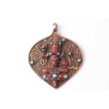 A Tibetan white metal blind filigree worked leaf-shaped pendant mounted with a figure of Green