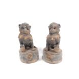 A pair of Chinese carved wood temple lions, Qing, each carved with a paw upon a ball, traces of