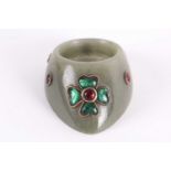 An Indian moss green jade archer's ring yellow metal set with cabochon hardstone flowers and boss