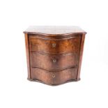 An 18th-century German burr elm serpentine fronted three-drawer commode chest, 68 cm high x 73 cm