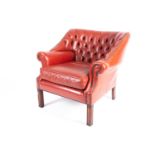 A 20th-century red deep button upholstered 'Chesterfield' armchair with close nailed detail and