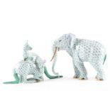 A large Herend porcelain model of an elephant, in green fishnet pattern with gilt tusks and