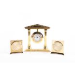 A Bueche Girod gilt metal dressing table clock, of temple form, the suspended circular dial with