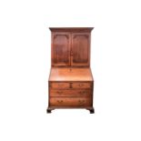 A George III mahogany bureau bookcase. The upper section with a pair of figured panel doors with