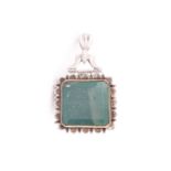A large Indo Persian green stone pendant in white metal mount, the square stone engraved with
