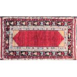 An early 20th-century crimson red ground Turkish rug with an open field within a gul firangi