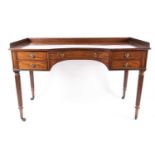 A George III Gillows of Lancaster mahogany kneehole library/ dressing table. With curved and