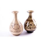 Two Chinese Cizhou vases, the taller vase carved in low relief with two panels of lotus flowers,