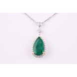 An emerald and diamond pendant necklace, the pear cut emerald measuring 17.2 x 10mm approximately,