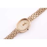 A 9ct yellow gold Geneve ladies wristwatch with oval gilt baton dial, on articulated bracelet, 18 cm
